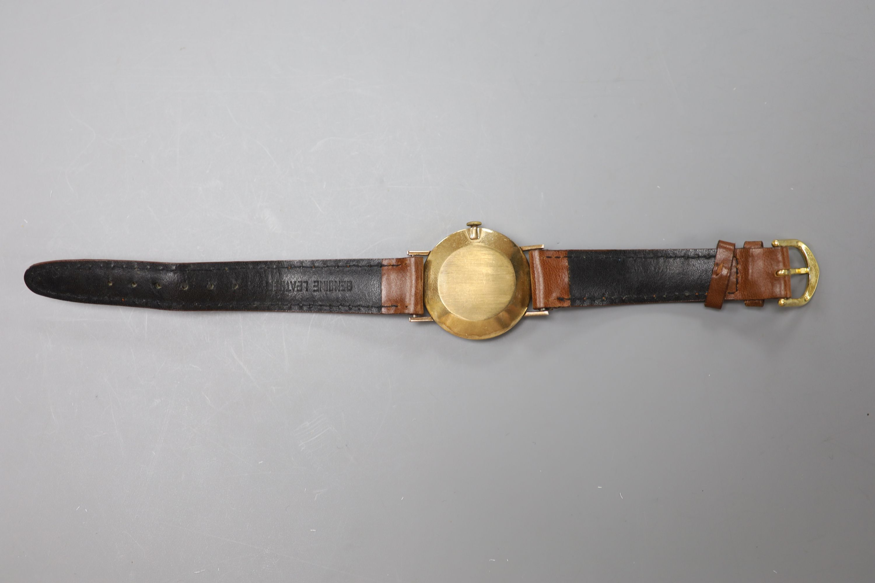 A gentleman's late 1950's 9ct gold Longines manual wind wrist watch, on a leather strap, case diameter 31mm, gross 27.2 grams.